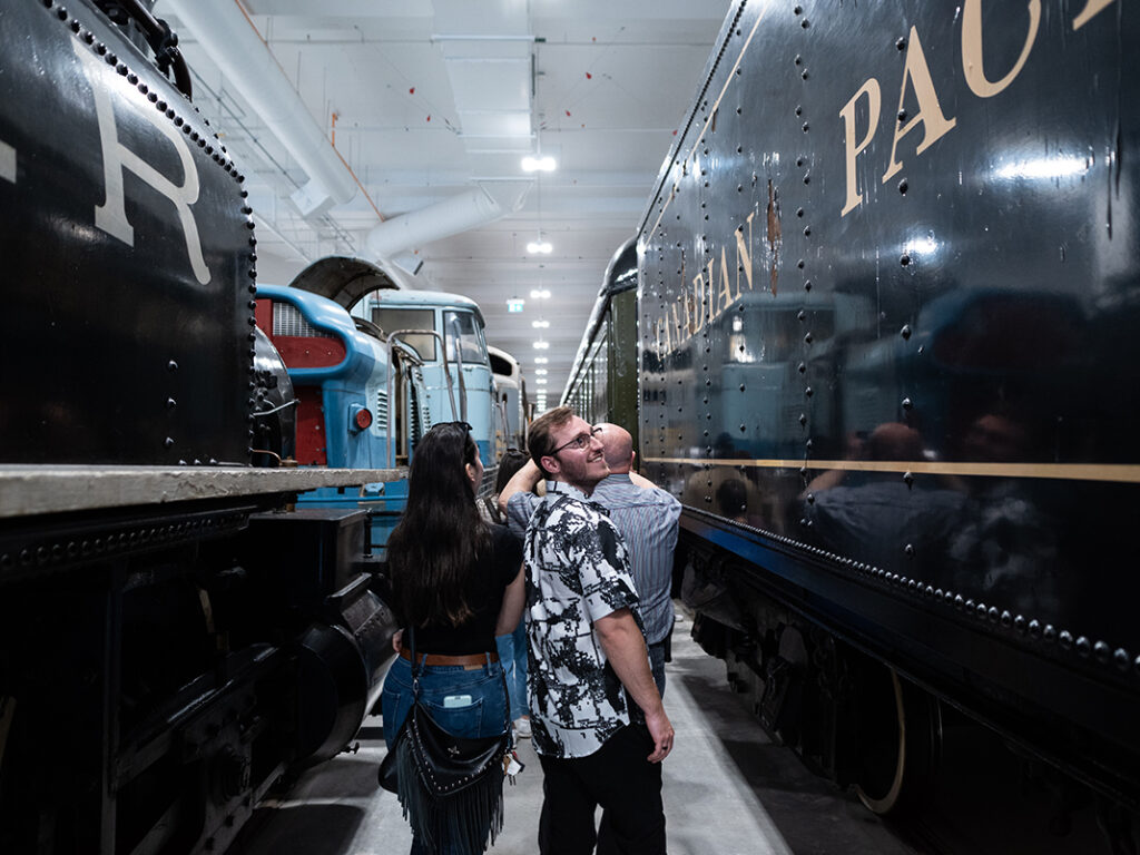 A group of people visiting the Ingenium’s collection and looking at the last steam locomotive built by the Canadian Pacific Railway.